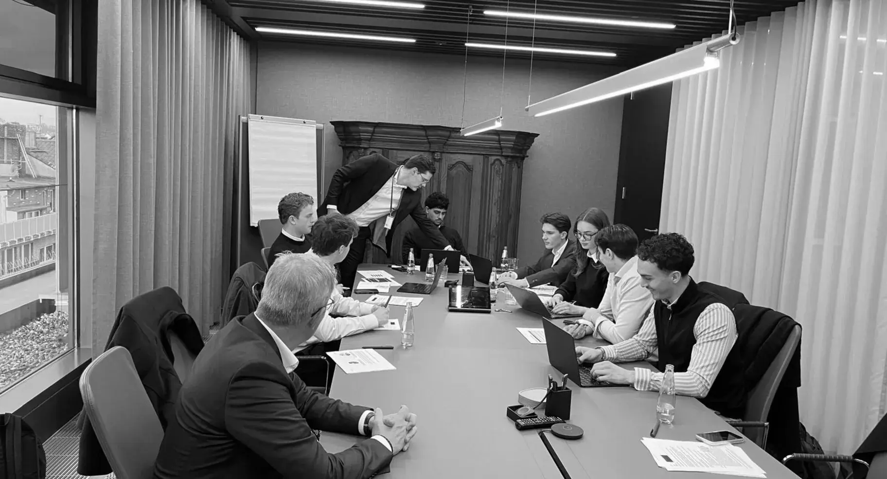 Members working through a case around a boardroom table