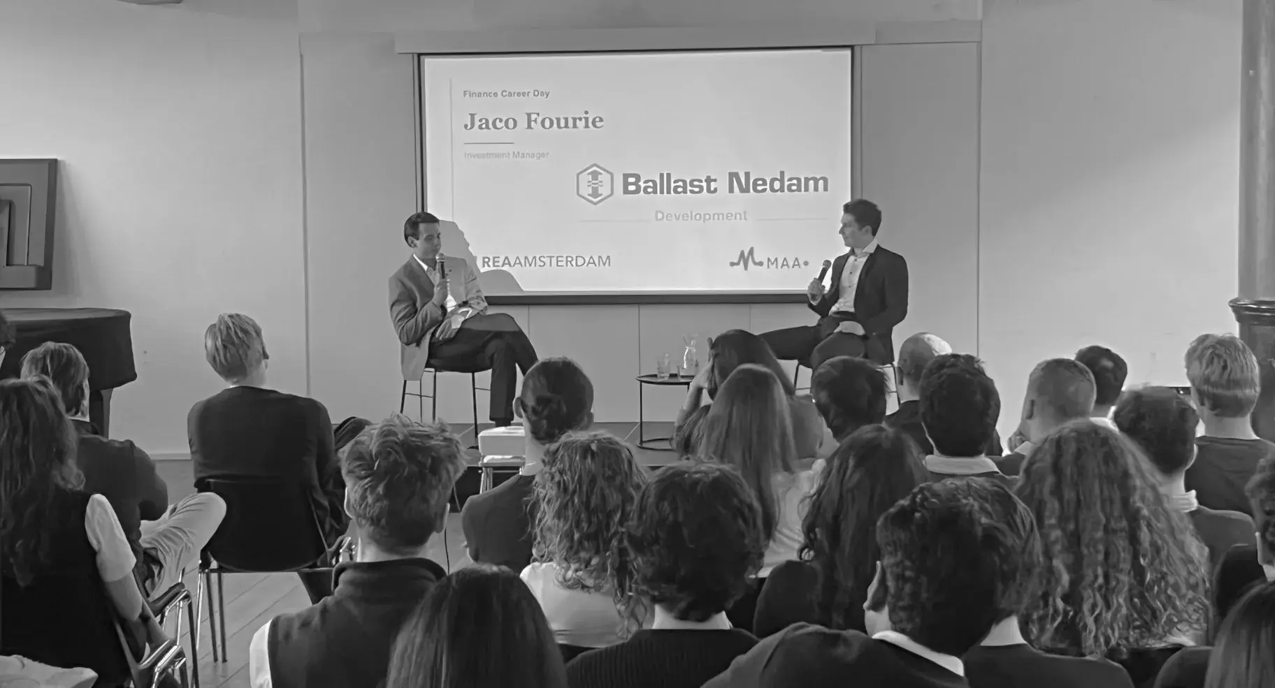 A moderated panel in front of a full audience