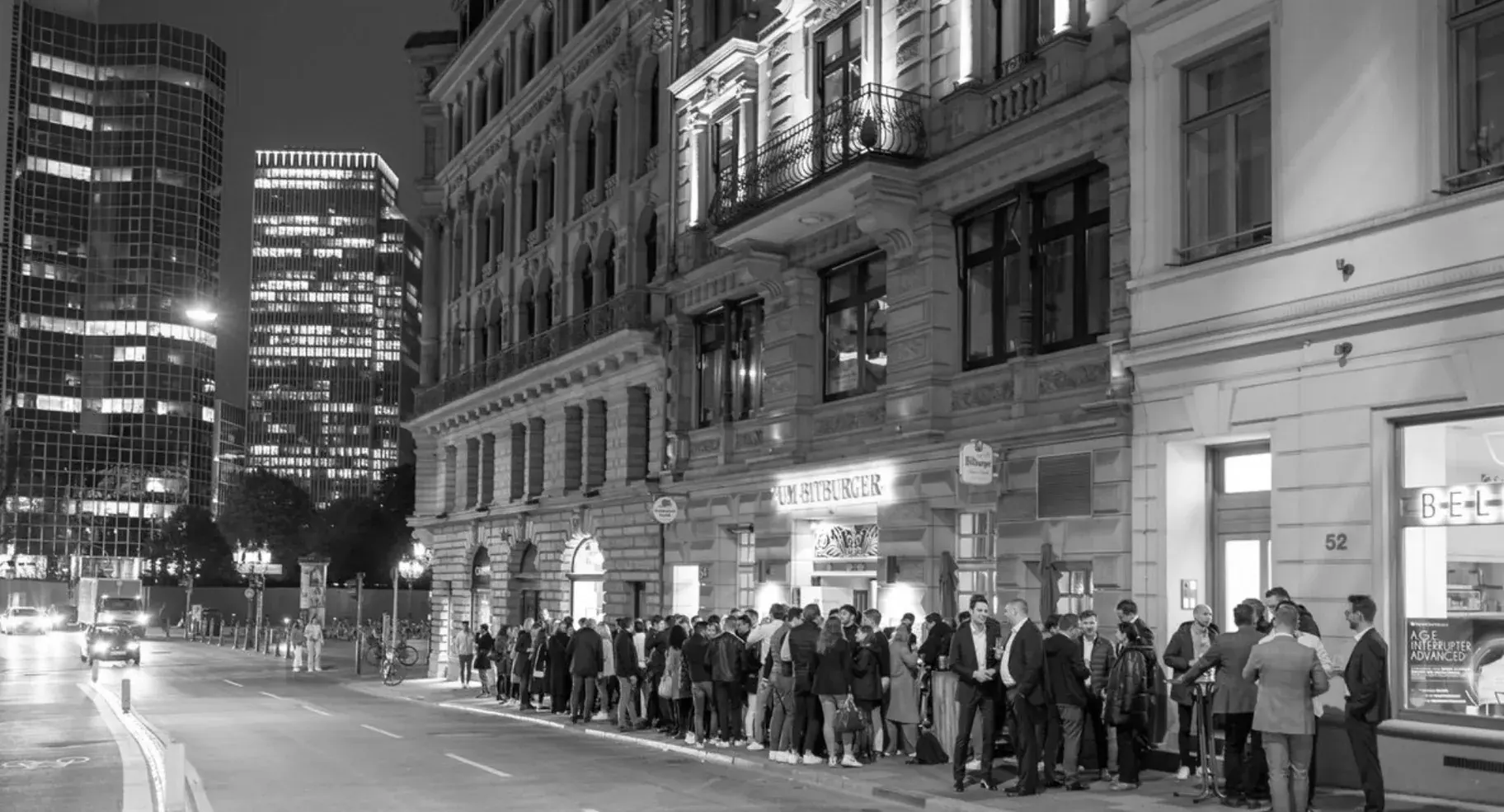 The group outside Bitburger in the evening, with the Frankfurt skyline behind