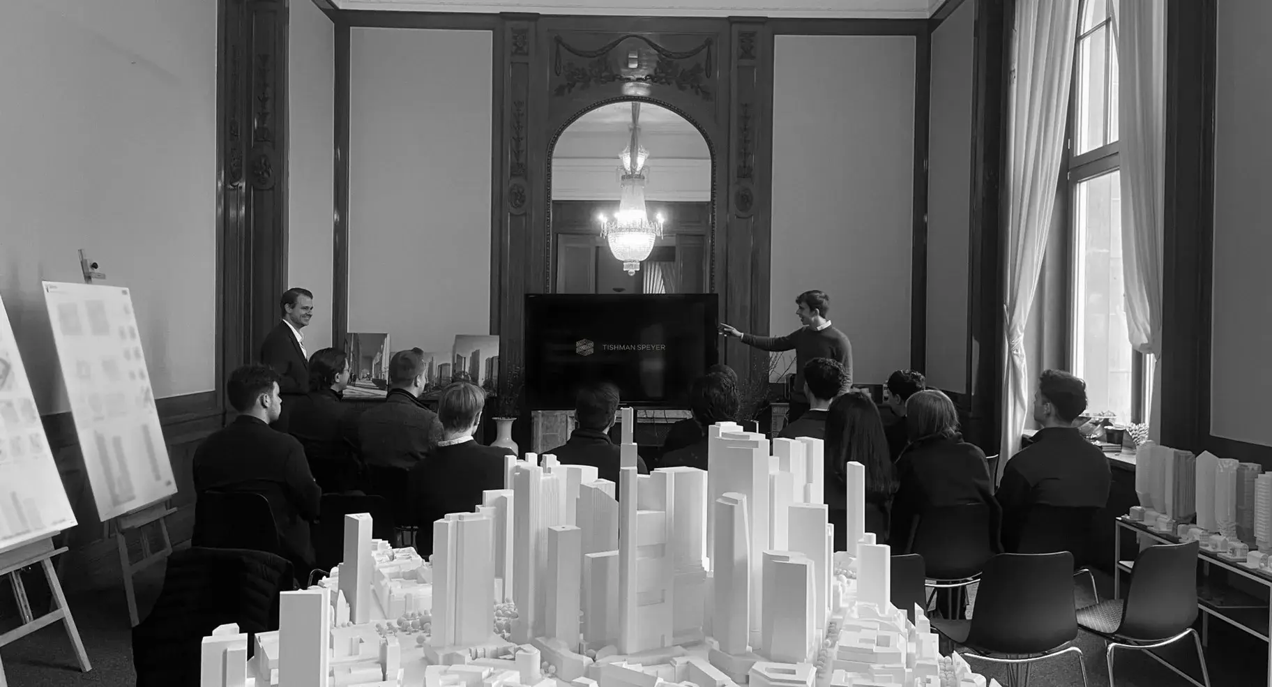 A presentation at Tishman Speyer beside a model of the Frankfurt skyline