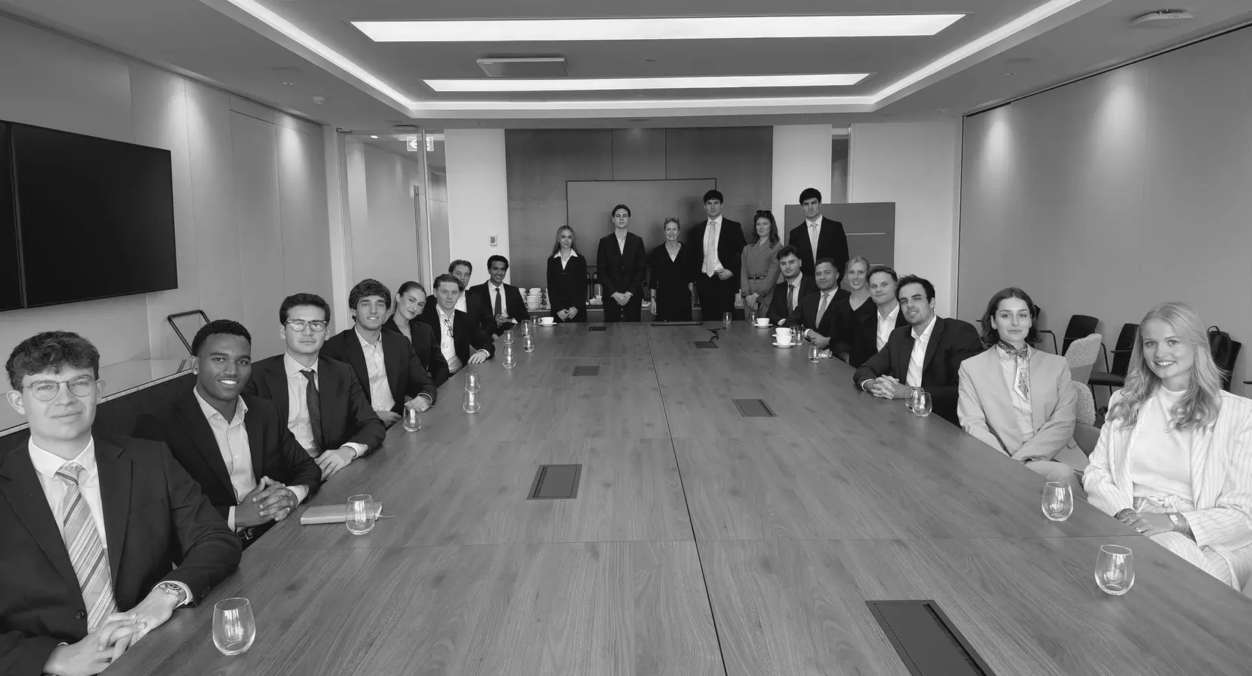 Members around the boardroom table with their hosts
