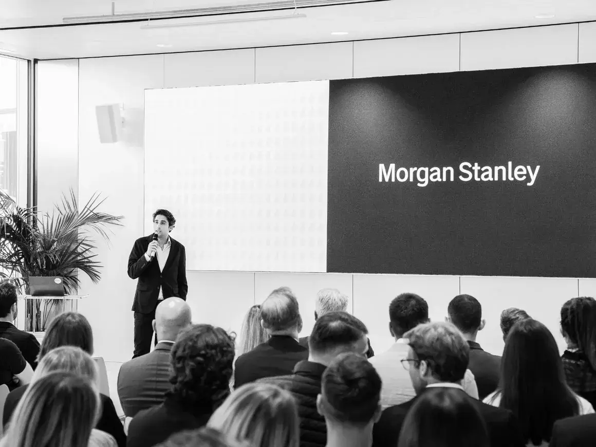 A speaker in front of a Morgan Stanley screen in St. Gallen