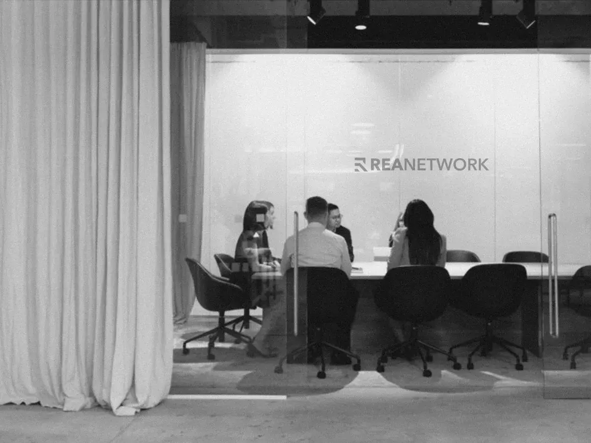 A meeting under the REA wordmark