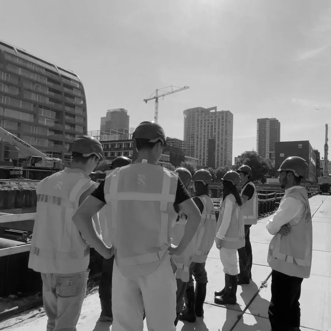 Members in high-visibility vests touring a construction site